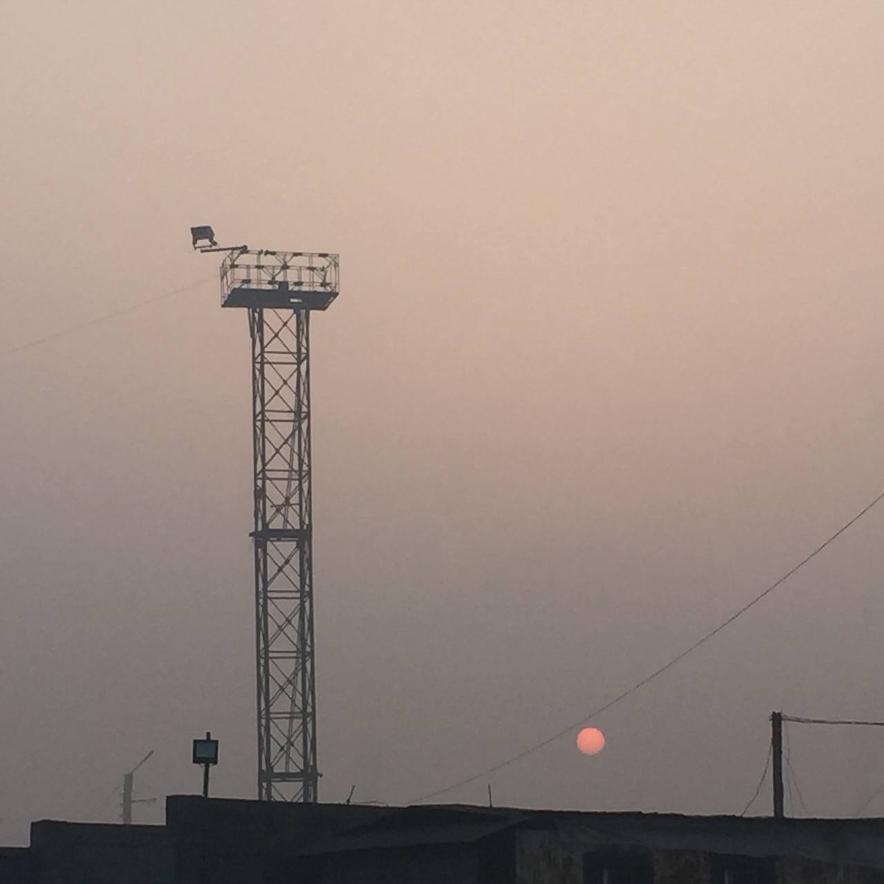 a tower with a red sun